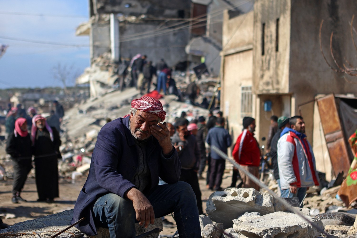 Un hombre sirio llora sentado sobre los escombros de un edificio derrumbado en Jindayris